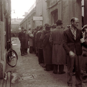 Photo of Jewish refugees waiting in line to enter or exit the ghetto.